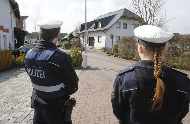 Police hold media away from the house where Andreas Lubitz lived in Montabaur, Germany, Thursday, March 26, 2015. Lubitz was the copilot on flight Germanwings 9525 that crashed with 150 people on board on Tuesday in the French Alps.
