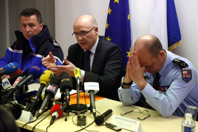 Marseille prosecutor Brice Robin, center, with Gen. David Galtier, right,holds a press conference in Marseille, southern France, Thursday March 26, 2015. Robin said the co-pilot was alone at the controls of the Germanwings flight that slammed into an Alpine mountainside and "intentionally" sent the plane into the doomed descent, killing 150 people.