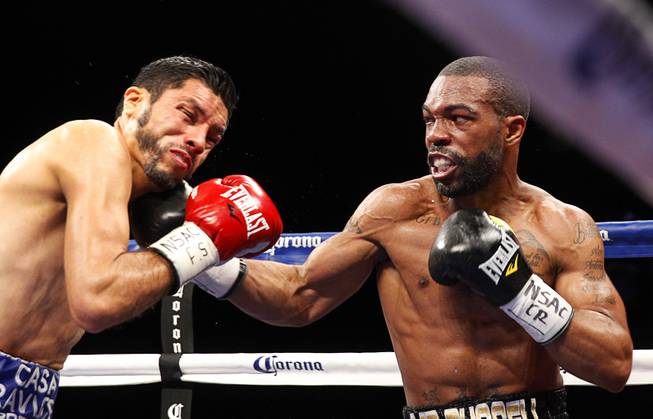 Gary Russell Jr., right, of Washington D.C., connects with a punch on WBC featherweight champion Jhonny Gonzalez of Mexico during their title fight at the Palms Saturday, March 28, 2015. Russell took the title with a fourth-round TKO.