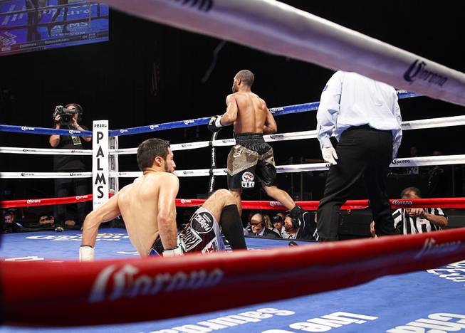 Gary Russell Jr. of Washington D.C. heads to a neutral corner after knocking down WBC featherweight champion Jhonny Gonzalez of Mexico in the third round of their title fight at the Palms Saturday, March 28, 2015.