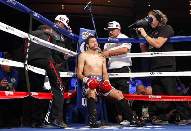 WBC featherweight champion Jhonny Gonzalez of Mexico gets treated in his corner after being knocked down by Gary Russell Jr. of Washington D.C. in the the third round at the Palms Saturday, March 28, 2015.