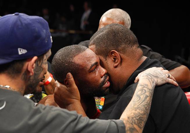 Gary Russell Jr., center, of Washington D.C. is congratulated in his corner after defeating WBC featherweight champion Jhonny Gonzalez of Mexico at the Palms Saturday, March 28, 2015. Russell took the title with a fourth-round TKO.
