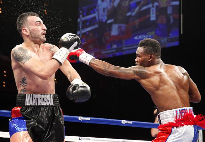Jermell Charlo, right, of Richmond, Texas, connects on Vanes Martirosyan of Armenia during their super welterweight bout at the Palms Saturday, March 28, 2015.
