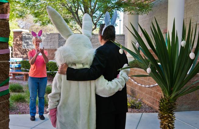 The Easter Bunny stands for a picture with Deacon Thomas Roberts at Catholic Charities of Southern Nevada during an early Easter holiday party for children in need on Saturday, March, 28, 2015.