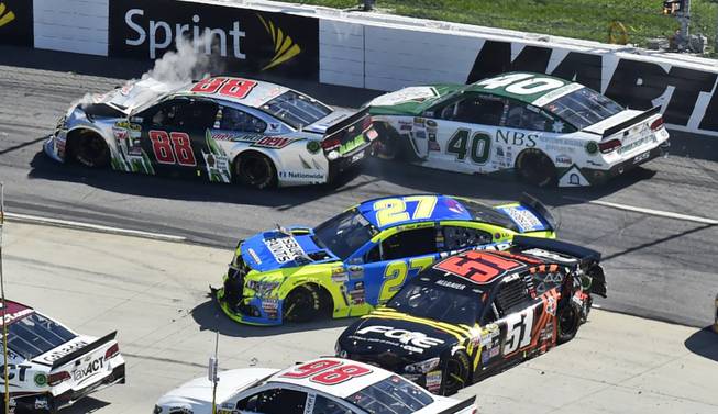 Dale Earnhardt Jr. (88), Landon Cassill (40), Paul Menard (27) and Justin Allgaier (51) tangle during the NASCAR Sprint Cup auto race at Martinsville Speedway in Martinsville, Va., on Sunday, March 29, 2015. 