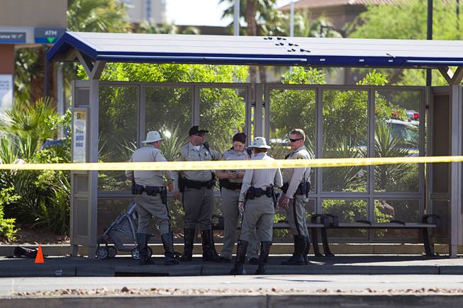 Metro Police officers confer after a hit-and-run accident at a bus shelter on Sahara Avenue at Maryland Parkway Monday, March 30, 2015.