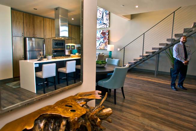 An open kitchen at Vantage Lofts features wooden flooring, decorative cabinetry and access to the living room and plenty of window light on Wednesday, March, 25, 2015.