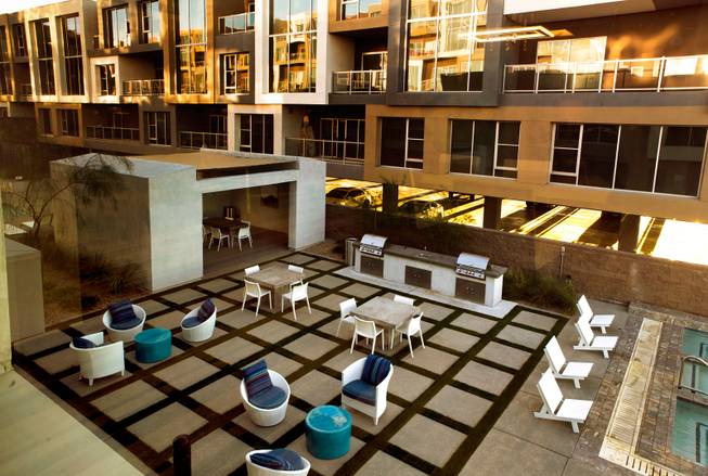 An garden-style patin between the pools at Vantage Lofts features several barbecues, seating and a covered dining area for residents and guests on Wednesday, March, 25, 2015.