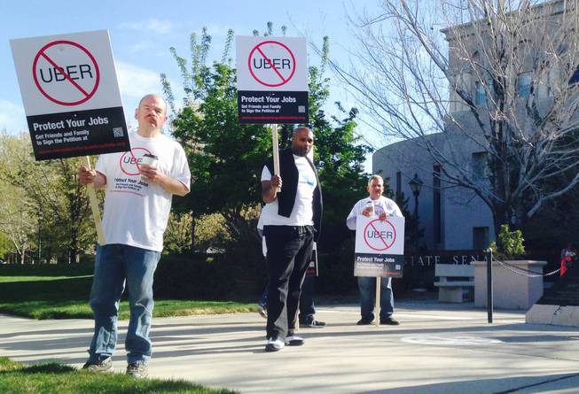 People outside the state Senate building in Carson City on Monday, March 30, 2015, protest bills that would allow ride-share companies like Uber to operate in Nevada.