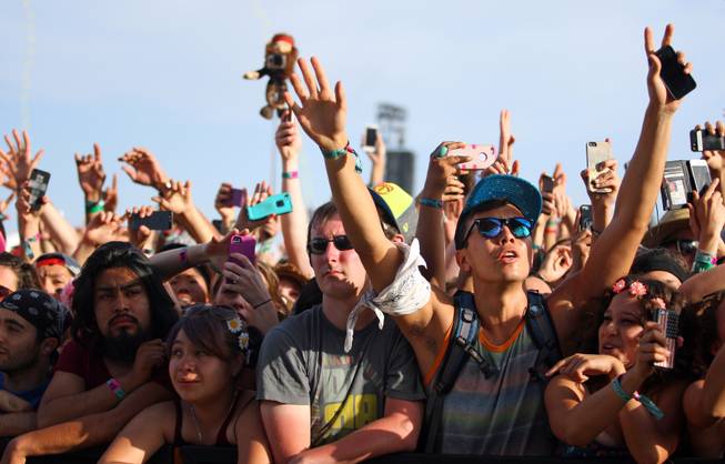 FILE - In this April 19, 2014 file photo, festival goers hold up cameras and phones during the 2014 Coachella Music and Arts Festival in Indio, Calif. You can bring your beach towels and floral headbands, but forget that selfie stick if you’re going to the Coachella or Lollapalooza music festivals. The sticks are banned this year at the events in Indio, Calif., and Chicago. Coachella dismissed them as “narsisstics” on a list of prohibited items. Selfie sticks have become a popular but polemical photo-taking tool: Avid picture takers like perching their cellphones on the lengthening devices to snap their own shots in front of monuments and sunsets, but critics dismiss them as obnoxious and potentially dangerous to others. Museums in the U.S. and Europe, including the Palace of Versailles outside Paris and Britain’s National Gallery in London, have banned them. 
