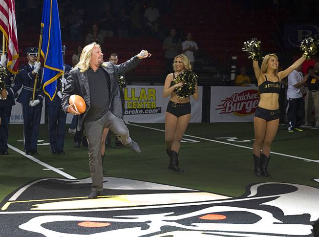 Motley Crue singer and Las Vegas Outlaws owner Vince Neil performs the national anthem during the Outlaws' inaugural game against the San Jose SaberCats at the Thomas & Mack Center Monday, March 30, 2015.