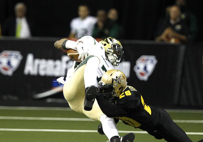 Darius Reynolds (7) is tackled by Outlaws' Tanner Varner (20) during the Outlaws' inaugural game against the San Jose SaberCats at the Thomas & Mack Center Monday, March 30, 2015.