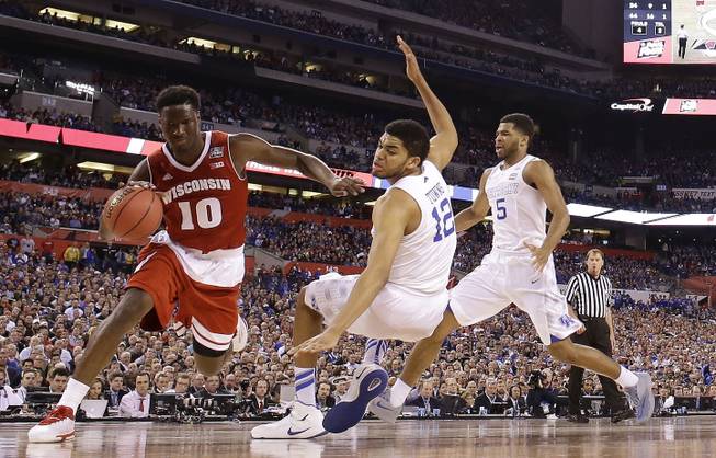 Wisconsin's Nigel Hayes (10) drives against Kentucky's Karl-Anthony Towns (12) during the second half of the NCAA Final Four tournament college basketball semifinal game Saturday, April 4, 2015, in Indianapolis. 