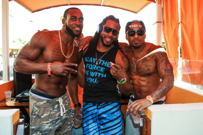 Richard Sherman, center, and friends at Tao Beach on Saturday, ...
