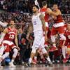 The Wisconsin bench celebrates as Kentucky's Willie Cauley-Stein walks off after the NCAA Final Four tournament semifinal game Saturday, April 4, 2015, in Indianapolis. Wisconsin won 71-64.