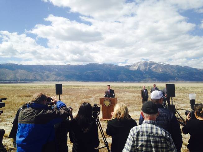 Standing on what used to be the bottom of Washoe Lake, Gov. Brian Sandoval signed an executive order that will assemble a panel of experts to investigate how Nevada can reduce its consumption of water Wednesday, April 8, 2015. 