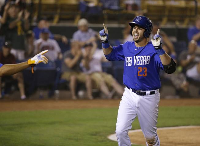 Las Vegas 51s catcher Kevin Plawecki celebrates after hitting a home run to tie the game against the Reno Aces during the Pacific Coast League conference championship series Wednesday, Sept. 3, 2014, in Las Vegas.