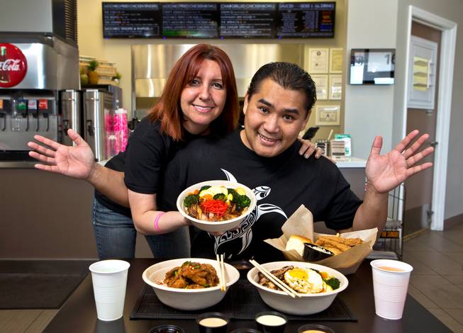 Mochiko Chicken owners Sandra Lenska and Jerry Misa with some of their tasty dishes on Tuesday, April, 7, 2015.