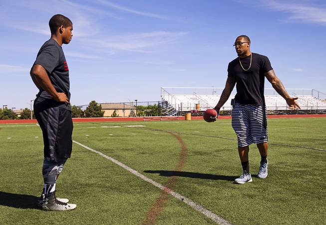 Las Vegan Korey Toomer, an NFL linebacker with the St. Louis Rams, gives tips to his younger brother Kameron Toomer of Palo Verde during the 13th annual Phase 1 Sports Football Combine and Skills Camp at Faith Lutheran High School Sunday, April 12, 2015. Korey Toomer went to high school in Las Vegas, Mohave and Shadow Ridge, and played the University of Idaho before going to the NFL.  .