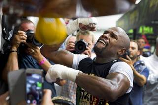WBC/WBA welterweight champion Floyd Mayweather Jr. hits a speed bag at the Mayweather Boxing Club Tuesday, April 14, 2015. Mayweather will face WBO welterweight champion Manny Pacquiao of the Philippines in a unification bout at the MGM Grand Garden Arena on May 2.  .