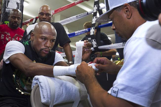 WBC/WBA welterweight champion Floyd Mayweather Jr. has his hands wrapped by Bob Ware on Tuesday, April 14, 2015, at Mayweather Boxing Club in Chinatown. Mayweather will face WBO welterweight champion Manny Pacquiao in a unification bout at MGM Grand Garden Arena on May 2.