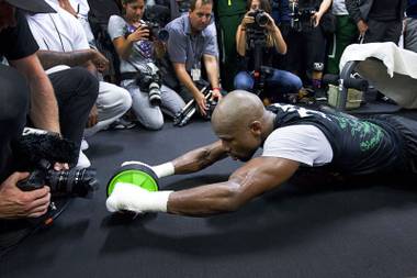 WBC/WBA welterweight champion Floyd Mayweather Jr., center, works on his abdominal muscles at the Mayweather Boxing Club Tuesday, April 14, 2015. Mayweather will face WBO welterweight champion Manny Pacquiao of the Philippines in a unification bout at the MGM Grand Garden Arena on May 2. .
