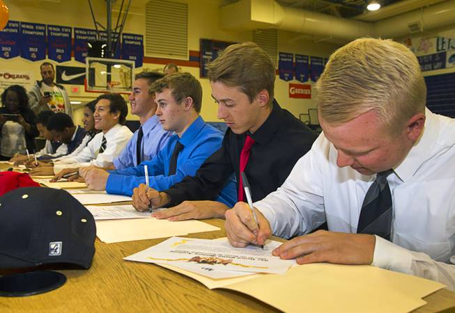 Chase Maddux, second right, and other student-athletes sign national letters of intent during a signing day ceremony at Bishop Gorman High School Wednesday, April 15, 2015. Maddux, son of former MLB pitcher Greg Maddux, signed a letter of intent to play for UNLV. Baseball teammate Matt Hudgins, right, will play for the Unites States Military Academy in New York.  .