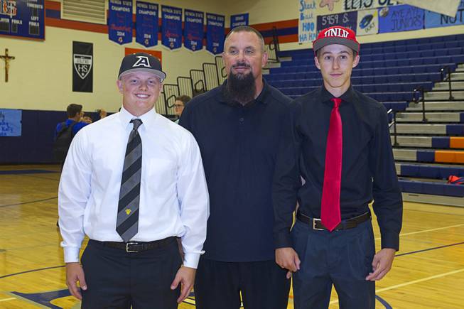 Baseball coach Gino DiMaria poses with Matt Hudgins, left, and Chase Maddux during a signing day ceremony at Bishop Gorman High School Wednesday, April 15, 2015. Chase Maddux signed a national letter of intent to play baseball for UNLV. Hudgins will play for the Unites States Military Academy in New York.  .