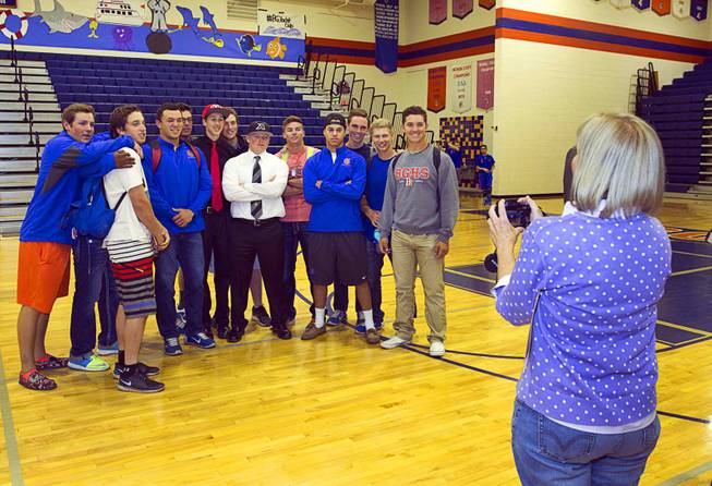 Barbara Hudgins takes a photo of baseball players, including Chase Maddux, center left, and her son Matt Hudgins, center, during a signing day ceremony at Bishop Gorman High School Wednesday, April 15, 2015. Eight student-athletes signed national letters of intent.  .