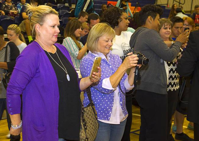 Kathy Maddux, left and Barbara Hudgins take photos of their sons during a signing day ceremony at Bishop Gorman High School Wednesday, April 15, 2015. Chase Maddux signed a national letter of intent to play baseball for UNLV. Hudgins will play for the Unites States Military Academy in New York.  .