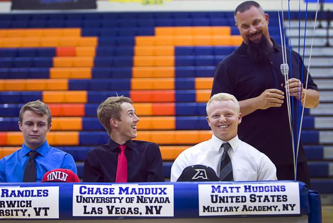 Baseball players Chase Maddux, center, and Matt Hudgins, right, react to comments by baseball coach Gino DiMaria during a signing day ceremony at Bishop Gorman High School Wednesday, April 15, 2015. Chase Maddux signed a national letter of intent to play baseball for UNLV. Hudgins will play for the Unites States Military Academy in New York.  .