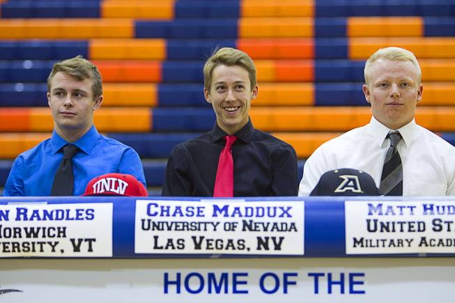 Wrestler Sean Randles Jr., left, and baseball players Chase Maddux, center, and Matt Hudgins participate in a signing day ceremony at Bishop Gorman High School Wednesday, April 15, 2015. Eight student-athletes signed national letters of intent.  .