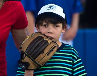 Fan Joseph Weiner nibbles on his glove at the Cashman Field as the Las Vegas 51s prepare to have their home opener versus the Fresno Grizzles at on Friday, April 17, 2015.  L.E. Baskow