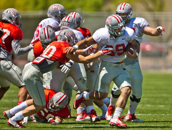 UNLV football player George Naufahu (39) pushes off defenders during the Spring Showcase, the last official gathering for the Rebels and coach Tony Sanchez before August on Saturday, April 18, 2015.