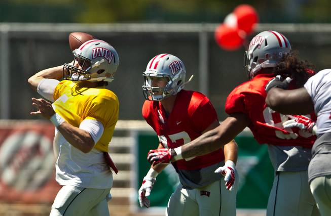 UNLV football QB Blake Decker (5) gets off a pass under pressure during the Spring Showcase, the last official gathering for the Rebels and coach Tony Sanchez before August on Saturday, April 18, 2015.