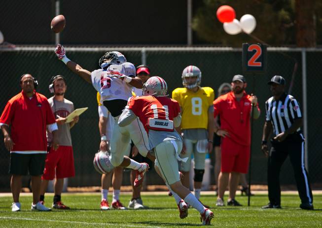 UNLV football player Anthony Williams (6) extends for a pass over Troy Hawthorne (11) during the Spring Showcase, the last official gathering for the Rebels and coach Tony Sanchez before August on Saturday, April 18, 2015.