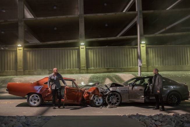 This photo provided by Universal Pictures shows Vin Diesel, left, as Dom Toretto and Jason Statham as Deckard Shaw in a scene from "Furious 7." The high-octane thriller "Furious 7" maintained its pace in its second week, speeding away with $60.6 million at North American theaters, bringing its box-office total to a robust $252.5 million, according to studio estimates Sunday, April 12, 2015.