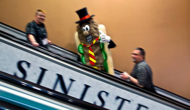 The Uncle John's Burger Dog mascot rides up an escalator during the star-studded CinemaCon Convention officially run by the National Association of Theatre Owners (NATO) at Caesars Palace on Tuesday, April 21, 2015.