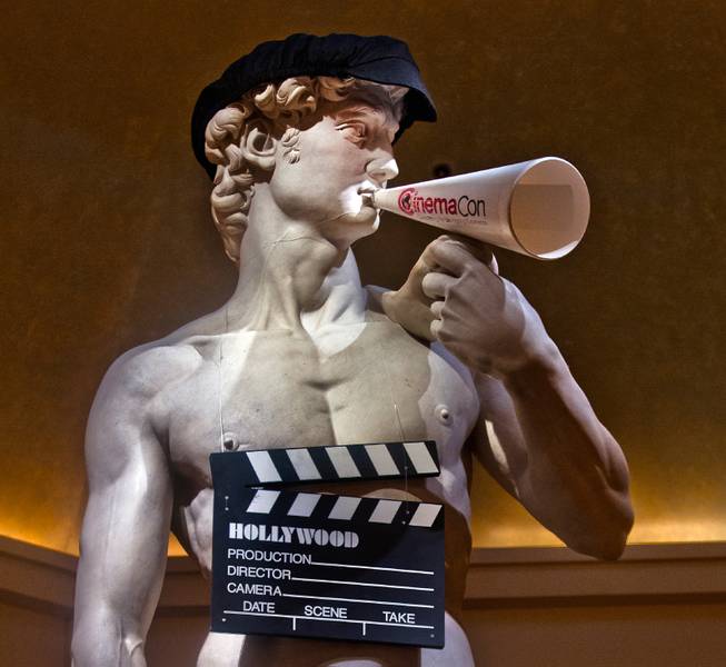 A Caesar statue is decked out with movie props for the star-studded CinemaCon Convention officially run by the National Association of Theatre Owners (NATO) at Caesars Palace on Tuesday, April 21, 2015.