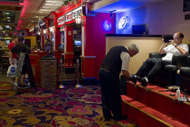 Shoe shine man Glenn Comeau shines a customer's shoes at the Riviera Wednesday, April 22, 2015. Comeau has been in the casino for 15 years but will be moving to the D Casino in downtown Las Vegas, he said. The casino, which opened on April 20, 1955, will close on May 4.   ..