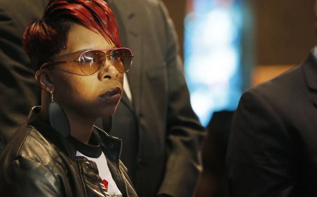 In this March 5, 2015, file photo, Lesley McSpadden, mother of Michael Brown Jr., listens to the family attorney during a news conference in Dellwood, Mo. Lawyers for the parents of Brown, the unarmed, black 18-year-old who was fatally shot by a white police officer in a St. Louis suburb, announced Wednesday, April 22, 2015, that they planned to file a civil lawsuit the following day against the city of Ferguson.