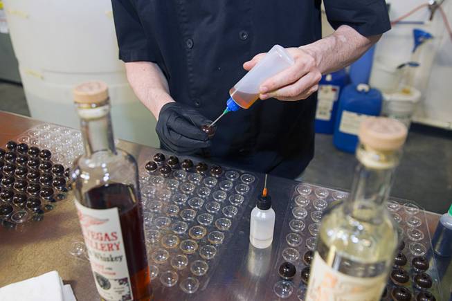 Cory Fields, a chocolatientist with MaXimum Chocolate Las Vegas, fills a chocolate ball with whiskey during the first St. George Day Spring Whiskey Barreling celebration at the Las Vegas Distillery in Henderson Saturday, April 25, 2015. St. George's Day remembers Saint George, England's patron saint. The distillery owner and his son are also named George.