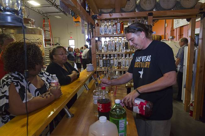 Stillman Sid Kindler gives out drink samples during the first St. George Day Spring Whiskey Barreling celebration at the Las Vegas Distillery in Henderson Saturday, April 25, 2015. St. George's Day remembers Saint George, England's patron saint. The distillery owner and his son are also named George.