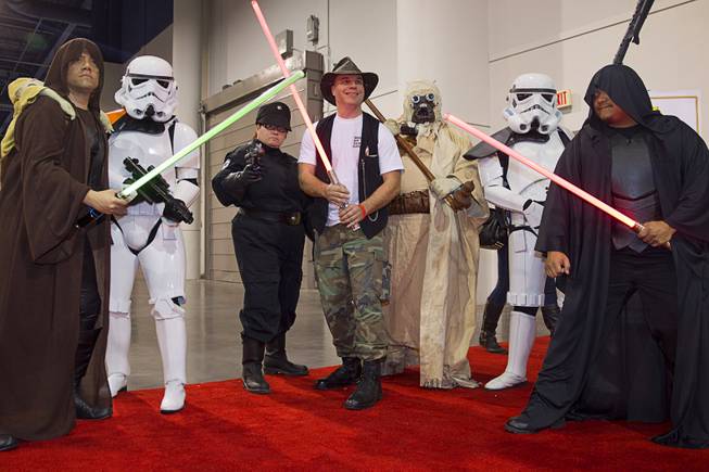 David Rancman of Cleveland, Ohio poses with fans dressed as Star Wars characters during the 2015 Wizard World Comic Con Las Vegas in the Las Vegas Convention Center Sunday, April 26, 2015.