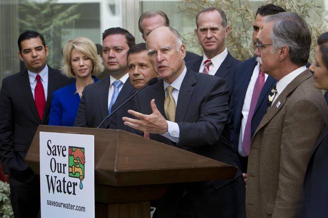 Gov. Jerry Brown talks during a news conference after meeting with several California mayors to discuss water conservation at the Capitol in Sacramento, Calif., on Tuesday, April 28, 2015. Gov. Brown called for $10.000 fines for residents and businesses that waste the most water as California cities try to meet mandatory conservation targets during the drought.