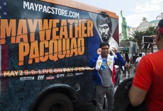 Fans stand by a van selling merchandise outside MGM Grand on Saturday, May 2, 2015, before the Floyd Mayweather Jr. vs. Manny Pacquiao fight.