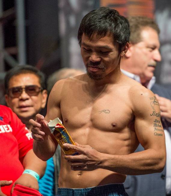 Manny Pacquiao enjoys Butterfinger Peanut Butter Cups during the weigh-in ...
