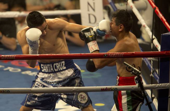 Leo Santa Cruz, left, fights Jose Cayetano in a featherweight boxing match at the MGM Grand Garden Arena on Saturday before the Floyd Mayweather Jr.-Manny Pacquiao fight on Saturday, May 2, 2015. 