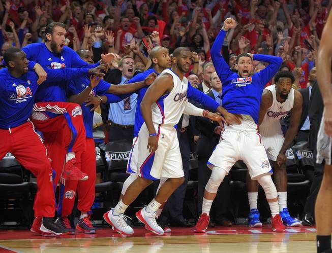 Members of the Los Angeles Clippers bench celebrate after guard Chris Paul, center, hit a basket with a second left in Game 7 in a first-round NBA basketball playoff series against the San Antonio Spurs, Saturday, May 2, 2015, in Los Angeles. The Clippers won 111-109.
