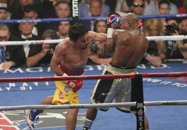 Manny Pacquiao connects on Floyd Mayweather during their fight Saturday, May 2, 2015.